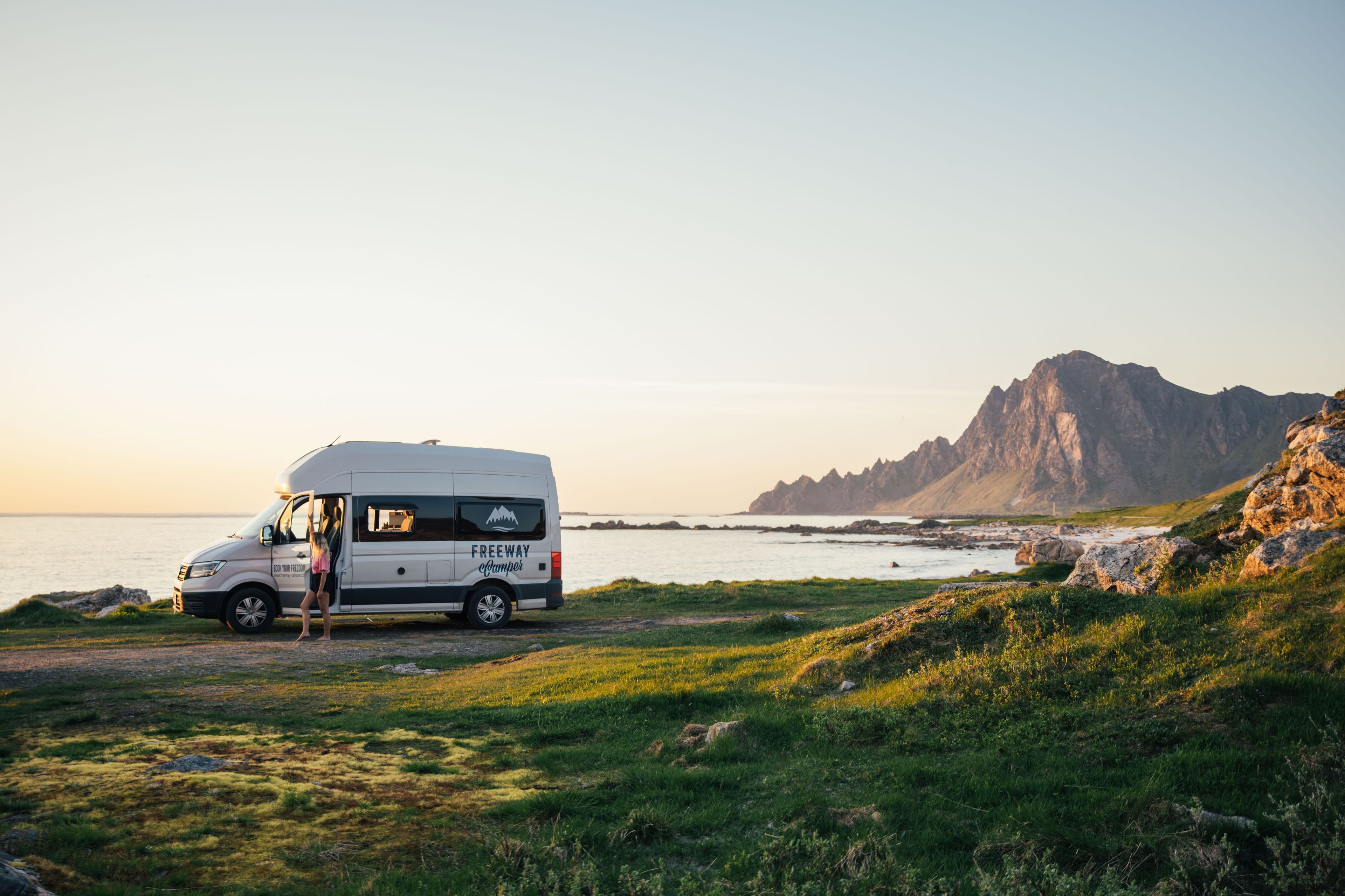 FWC Camper at the Norwegian coast, with sea and mountains in the background.